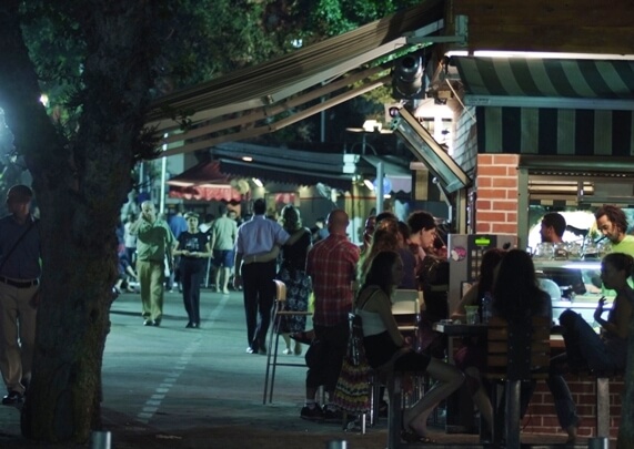 Walking in the evening along tree-lined Rothschild Boulevard in the heart of Tel Aviv